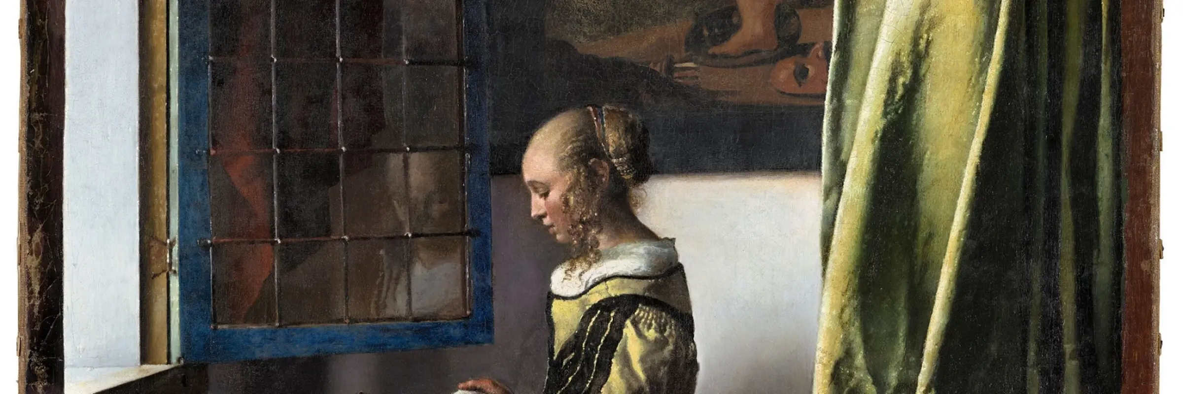 Girl standing at the window reading a letter