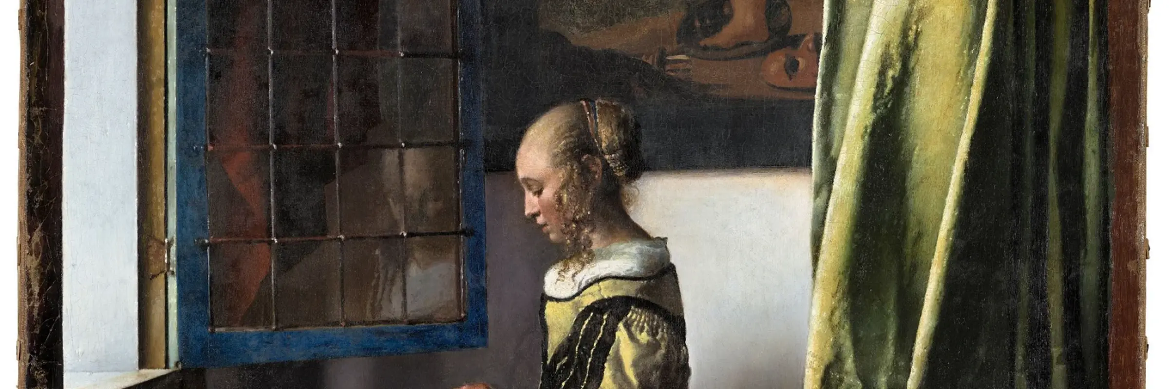 Girl standing at the window reading a letter