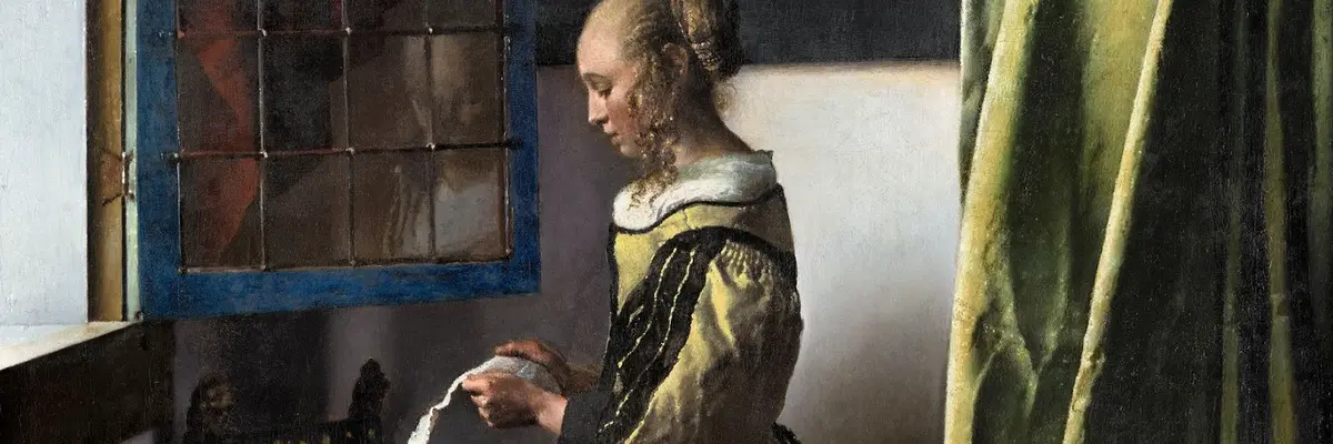 Girl standing at the window reading a letter