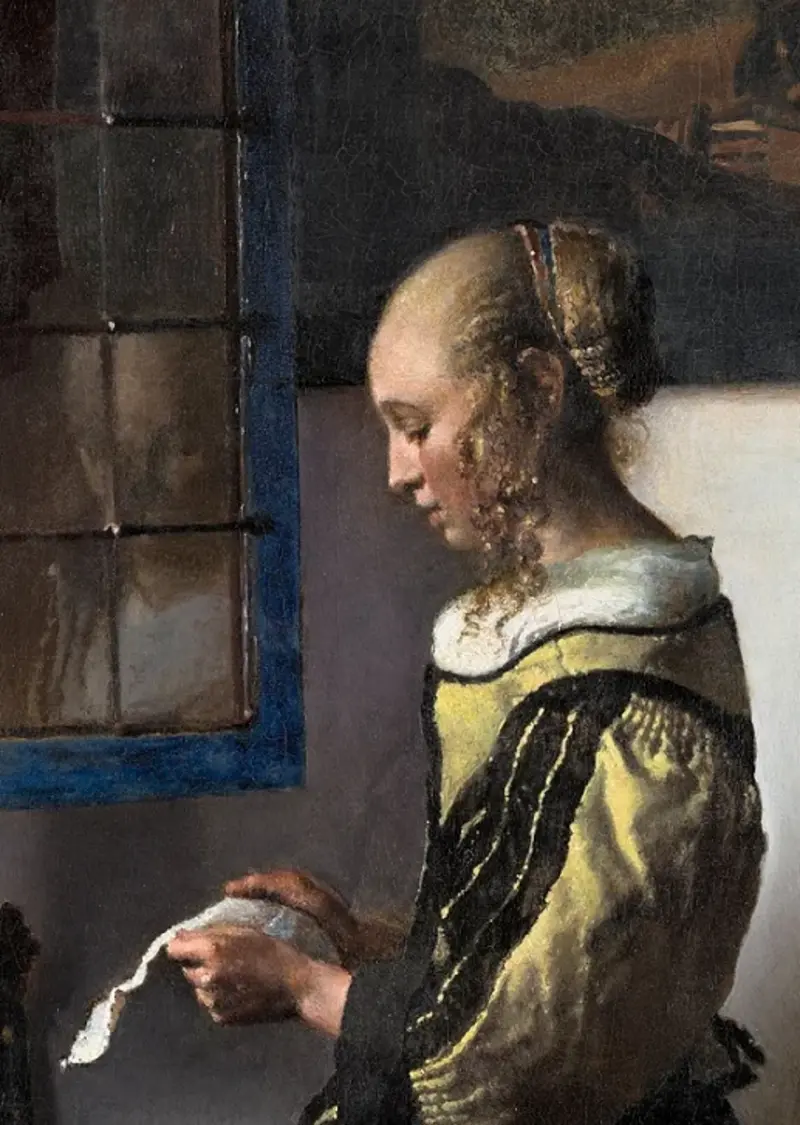 Girl standing at the window reading a letter