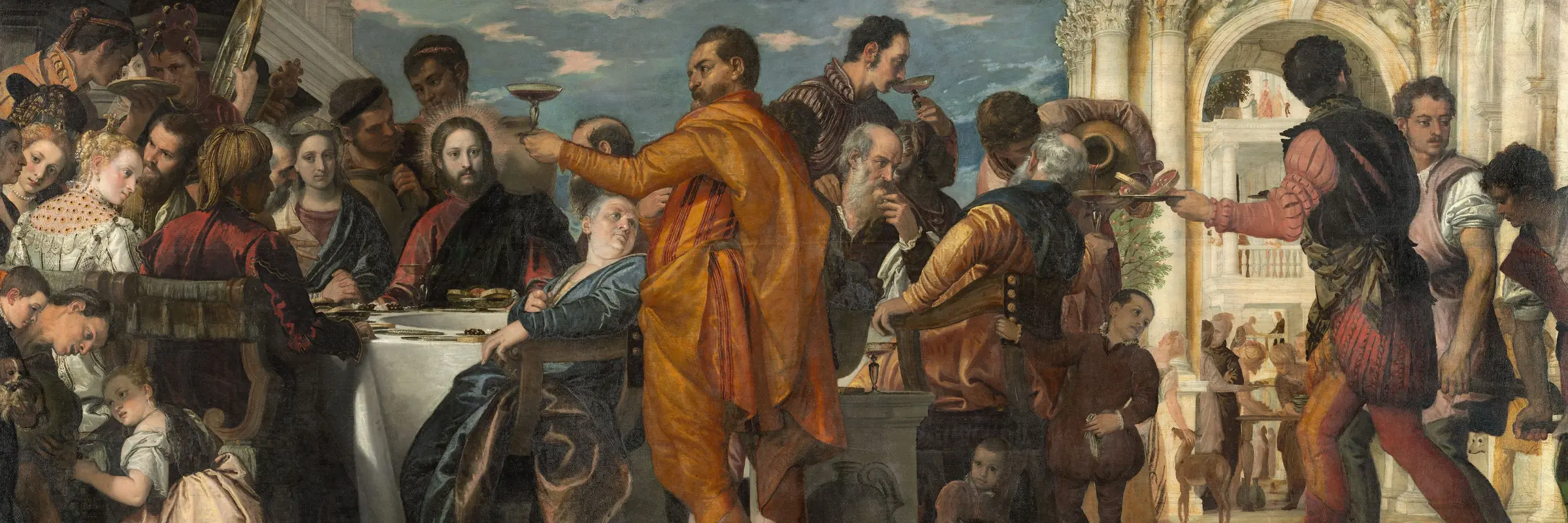Die Hochzeitsgesellschaft sitzt, mit Jesus im Mittelpunkt, um einen Tisch, daneben ein italienischer Palazzo